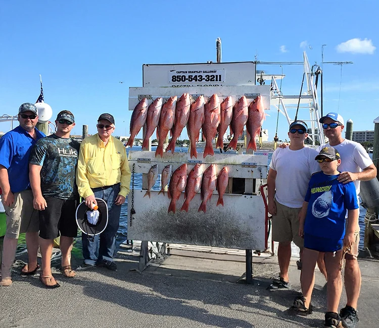Family showing the fish caught on their fishing adventure.