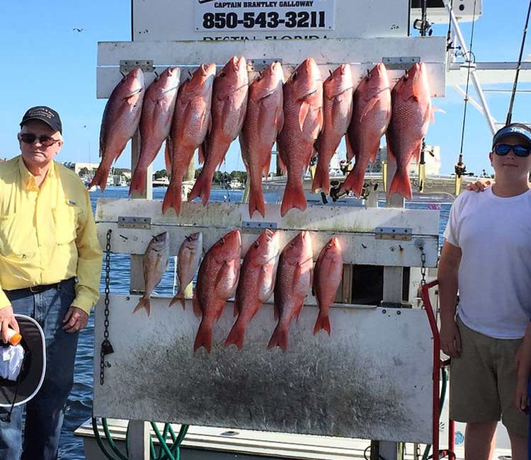 Family showing the fish caught on their fishing adventure.