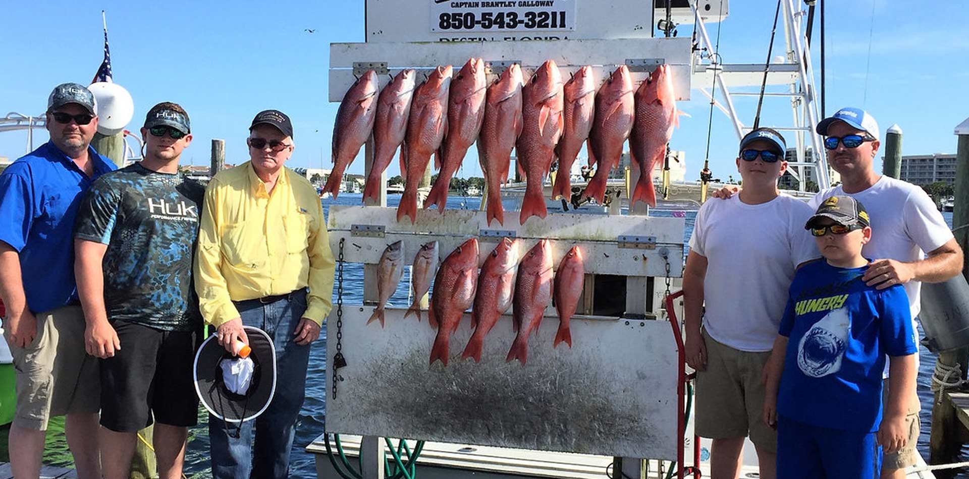 Family showing the fish caught on their fishing adventure.