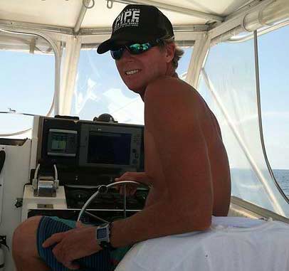 Captain Brantley Galloway at the helm of a boat