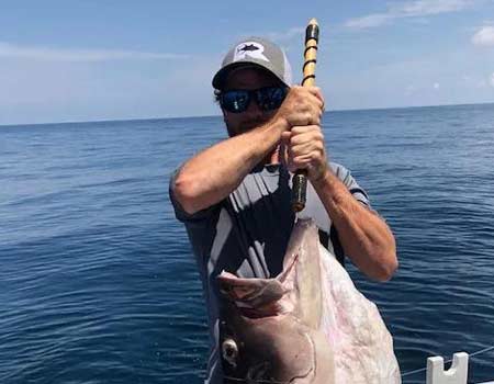  Man poses aboard the Fuyll Draw with his fish.