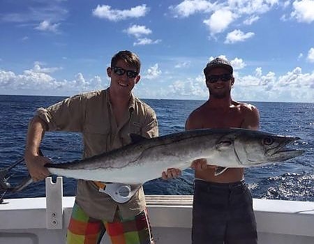  Two men pose aboard the Full Draw with their catch.