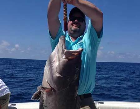  Fisherman posing with his large fish caught with HiLiner Charters.