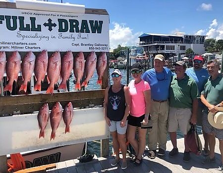  Family poses with the fish caught on their deep-sea expedition.