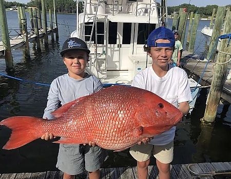  Two boys pose with their red snapper.